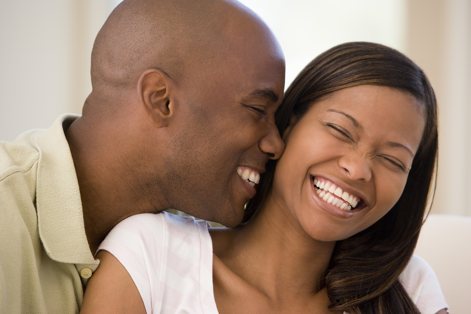 young black couple laughing together nice teeth and veneers Durham, NC cosmetic dentistry